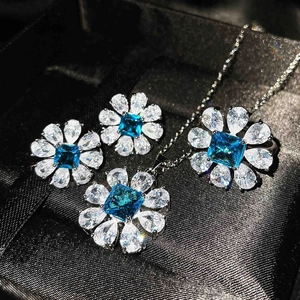 Elegant floral jewelry set featuring blue topaz-style stones and silver marquise gems