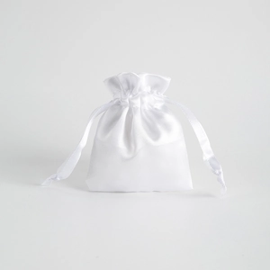 Detailed view of a white satin drawstring bag with a glossy finish for jewelry storage