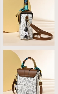 Detail of mini rabbit handbag featuring silk scarf handle and black bear charm accessory