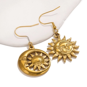 Macro view of vintage gold sun and moon face charms with antique texture details
