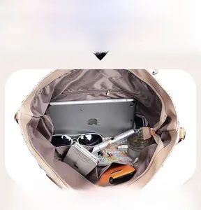 Internal view of the large capacity beige tote bag showing iPad and accessories
