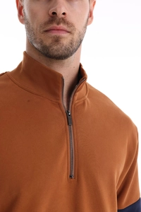 Detail of caramel polo neck sweatshirt with half-zip design and ribbed knit texture