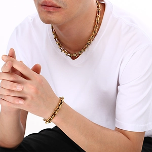 Detail view of 18K gold plated titanium steel chain necklace and bracelet on model
