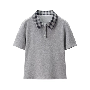 Detail of grey polo shirt featuring plaid collar and sparkling diamond buttons