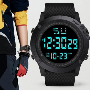 Macro detail of black digital sports watch with textured silicone strap and LED display