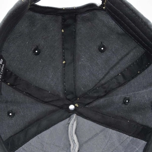 Detailed macro view of internal stitching and breathable vents on vintage baseball cap