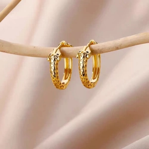 18k gold plated giraffe hoop earrings with textured animal patterns on beige silk