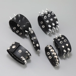 Five assorted punk style black leather bracelets with metallic studs and sharp spikes