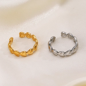 Minimalist 18K gold and silver plated stainless steel heart rings on beige silk fabric