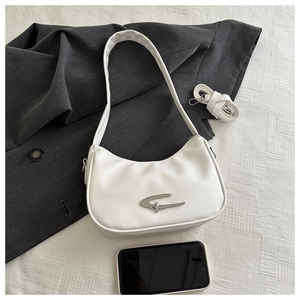 Close-up of white crescent shoulder bag with silver star moon metal buckle on marble