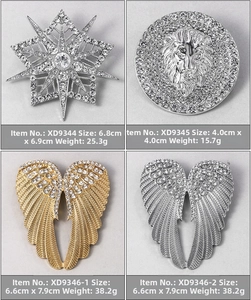 Detailed grid of four sparkling rhinestone brooches in star, lion, and wing designs