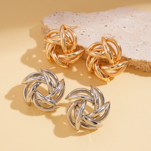 Geometric hollow flower earrings in gold and silver finish with metallic swirl design