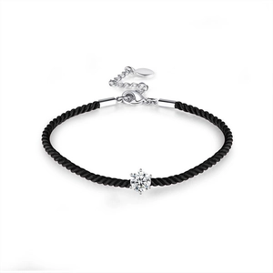 Detail of black woven couple bracelet with silver lobster clasp and sparkling cubic zirconia