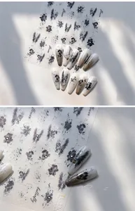 Detailed macro view of vintage black butterfly and flower embossed nail art stickers