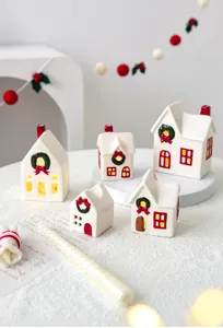 Set of five white ceramic Christmas village houses with red chimneys and festive wreaths