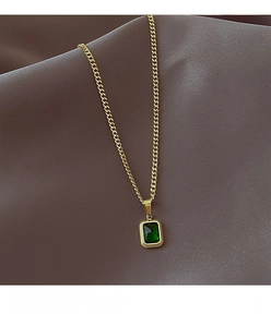Detail of emerald rectangular gemstone pendant with gold-plated thin curb chain