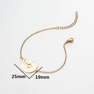 Gold moon and cat pendant bracelet with lobster clasp on a clean white background