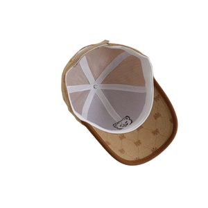 Brown corduroy baseball cap for kids featuring bear prints on the brim and internal lining