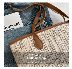 Detail of woven beige handbag with brown leather strap and stitching on denim background