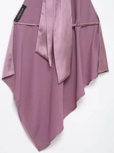 Detail of purple satin halter top featuring a smooth silky texture and branded label