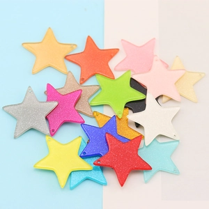 Close-up of colorful glitter resin star pendants with pre-drilled holes for DIY jewelry