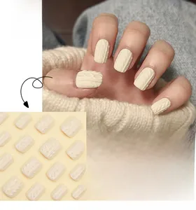 Short square press-on nails in cream white with 3D embossed cable knit texture