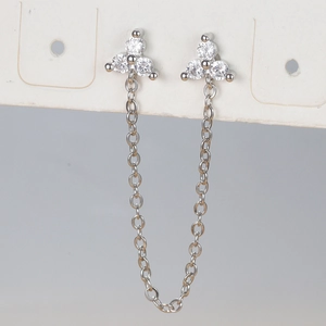 Detailed view of silver flower chain earrings with sparkling cubic zirconia on display card