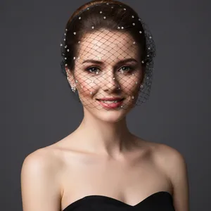 Detail of elegant black mesh bridal veil with silver rhinestones on thin headband