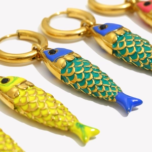 Macro shot of 18K gold plated fish earrings with colorful enamel scales and fine details