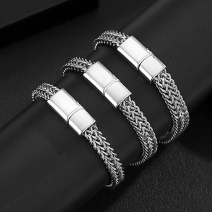 Macro detail of silver titanium cuban link bracelets with wheat chain texture and polished clasp