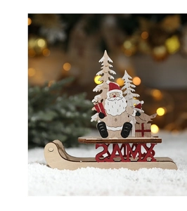 Detailed view of wood Christmas sleigh ornament with XMAS lettering on snowy surface