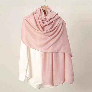 Detailed view of pink cotton linen scarf draped over a white shirt for women