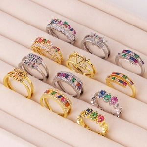 Geometric 18K gold plated zircon rings in colorful rainbow styles on pink velvet