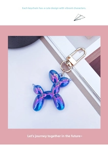Detailed close-up of a blue-purple electroplated balloon dog keychain with golden clasp