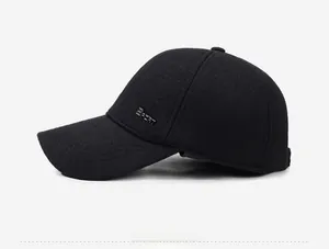 Detail of wool-like black baseball cap featuring a SPORT metal badge and warm texture