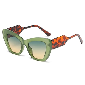Green cat eye sunglasses with tortoise temples and blue yellow gradient lenses