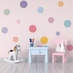 Vibrant colorful polka dot wall decals for kids bedroom decor on a soft pink background
