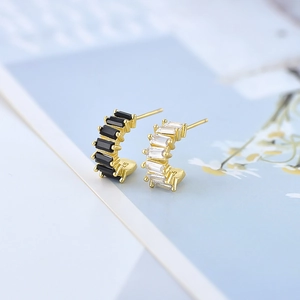 Macro detail of S925 hallmark on gold-plated earrings with zircon gemstones