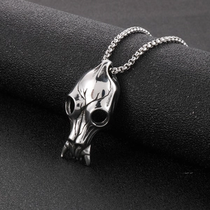 Macro view of silver punk animal skull pendant with sharp fangs and gothic vintage texture