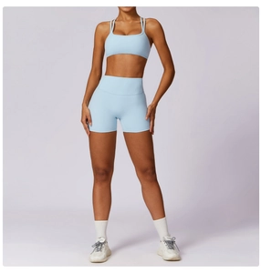 Close-up of light blue high-waist yoga shorts and strappy sports bra set for fitness