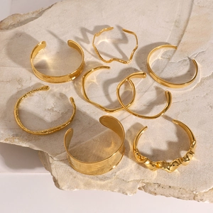 Eight-piece gold plated stainless steel cuff bracelet set with hammered textures on stone