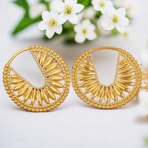 Golden stainless steel geometric hoop earrings with hollow petal pattern and beaded edge