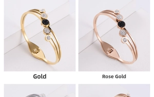 Detail of gold and rose gold hollow bangles featuring five circles with black and white crystals