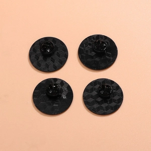 Set of four textured black round enamel pins with rainbow heart motif and secure backings