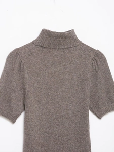 Detail of high neck knit mini dress with subtle puff sleeves and ribbed collar texture