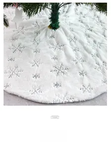 Close-up of white plush Christmas tree skirt featuring silver sequin snowflake embroidery