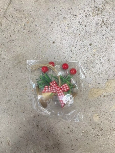 Detail of Christmas golden double bells with red plaid bow and pine needle decor