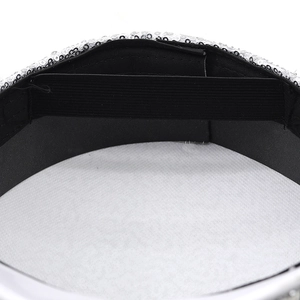 Detailed interior of sequined captain hat showing black lining and elastic band
