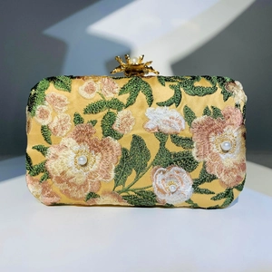 Elegant yellow embroidered clutch bag with floral pearls and golden flower clasp