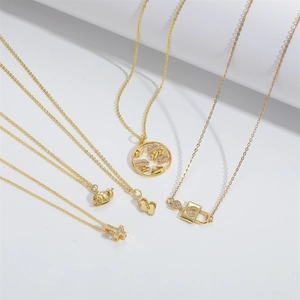 Detailed close-up of gold choker necklaces featuring cross, snail, and lip pendants
